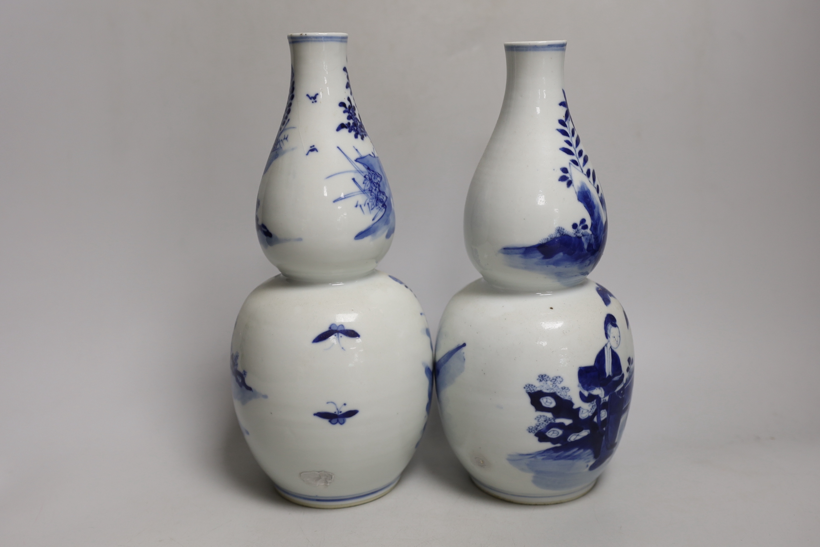 A pair of 19th century Chinese blue and white double gourd vases, 26cm high (a.f.)